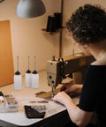 Woman using sewing machine with long mouth nozzle oil bottles for sewing machines and home tools three pack plastic oiler pots nearby