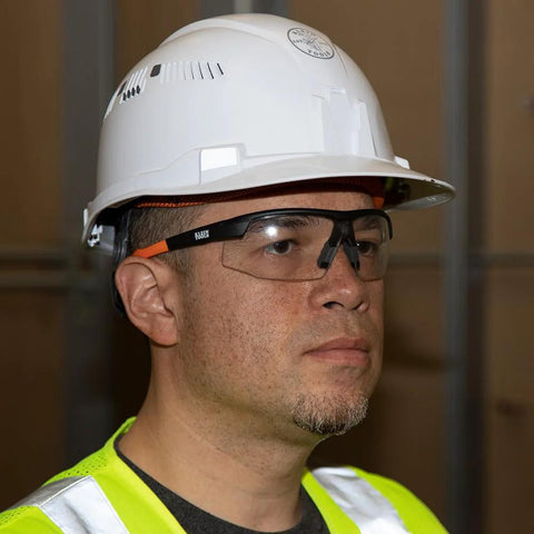 Man wearing Low Profile Safety Glasses Narrow Lens Z87 1 Anti Fog Scratch Resistant 2 Pack, in safety gear.