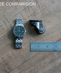 1 Inch Low Profile Swivel Caster Wheels 4 Pack size comparison with watch and ruler on wooden surface