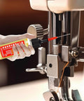 Hand applying Extend Door Lock Hinge Lubricant 60ml Grease And Penetrating Oil to sewing machine for smooth operation