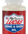 2 ounce bottle of Tool Box Buddy air tool lubricant from Lucas Oil, front view, with orange cap and red label, extends tool life.