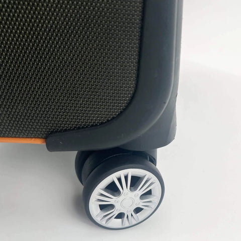 Close-up of a suitcase showing a black and silver wheel from the Luggage Replacement Wheels Set with 2 Wear Resistant Suitcase Wheels Made from TPE.