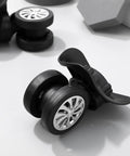 Close-up of 4 Piece Universal Luggage Wheels Replacement Kit For Suitcases, 360 Degree Silent Swivel Casters with silver accents.