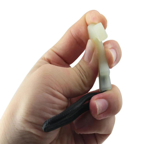 Close-up of a 8 Piece Luminous Tail Cord Zip Puller Set For Outdoor Backpacks 42x44mm Heavy Duty TPU Extender in hand, showing T-shape and nylon rope.