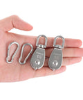 Hand holding 10Pcs M15 Single Pulley Block, 304 Stainless Steel Wire Rope Pulley, Lifting Pulley with 10 Spring Snap Hooks for Hanging and Lifting