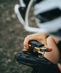 Cyclist using M17 Gold Bicycle Multi Tool With Hex Wrenches for trail shoe repair.