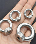 Four M3 stainless steel lifting eye nuts with shoulder ring for rigging and lifting on a hand, focus on metric thread M3 design.