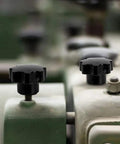 Five Pack M6 Internal Thread Clamping Knobs With 32mm Star Head Through Hole 7 Lobes Grip Black, installed on machinery