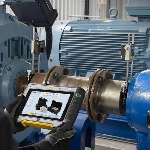 Person using a tablet to align machinery with 130-Piece 3-Inch By 3-Inch Slotted Stainless Steel Shim Set for tool calibration and alignment.