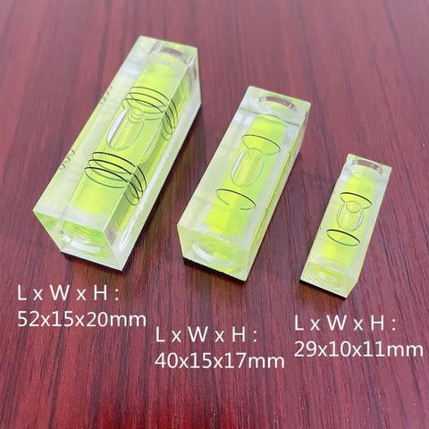Magnetic Square Bubble Level Set Of 5 Pieces With 29mm 40mm And 52mm Levels for precise carpentry and DIY measurements on wood surface.
