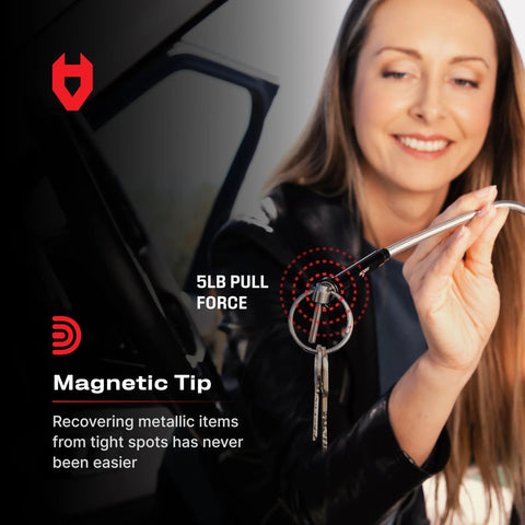 Woman using a flexible magnetic claw pickup tool with a bright LED light to retrieve keys from a tight spot, 5lb pull strength.