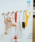 Refrigerator with multiple magnetic hooks holding kitchen utensils and decorative items, highlighting versatility and organization.