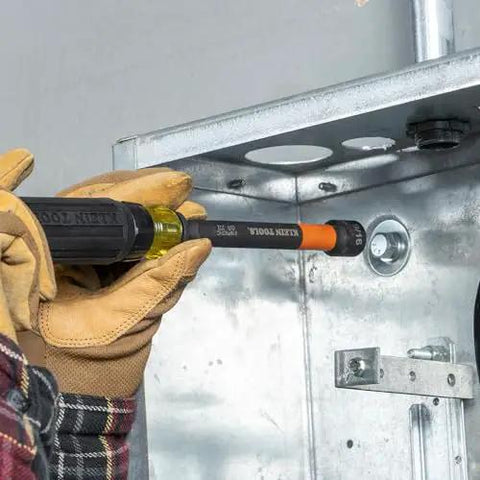Person using a Six Piece SAE Magnetic Impact Nut Setter Set With Color Coded Power Nut Drivers And Extended Reach For Heavy Duty Fastening Includes 1/4 5/16 3/8 7/16 1/2 9/16 Inch Sizes Rare Earth Magnets For One Hand Driving Klein Tools 32930 on a metal panel.