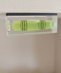 Close-up of a magnetic bubble level tool set showing green liquid vial for precise leveling in carpentry and DIY projects.