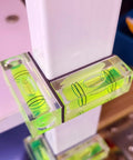 Magnetic Mini Bubble Level Tool Pack, Pocket Size, Ultra Precise 3Line Grid in use on white furniture for horizontal alignment