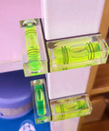 Magnetic Mini Bubble Level Tool Pack, Pocket Size, Ultra Precise 3Line Grid attached on a vertical surface