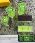 Magnetic Square Bubble Spirit Levels Set 3 Pack Mini Acrylic Level Tool For Precise Horizontal And Vertical Alignment With Pro Grade Magnetic Backing Handy And Reliable For Turntables And DIY Projects LAIESYA, showing compact green acrylic levels with magnetic backs on a metal surface.