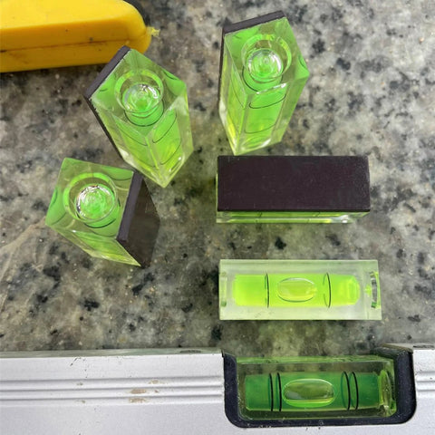 Magnetic Square Bubble Spirit Levels Set 3 Pack Mini Acrylic Level Tool For Precise Horizontal And Vertical Alignment With Pro Grade Magnetic Backing Handy And Reliable For Turntables And DIY Projects LAIESYA, showing compact green acrylic levels with magnetic backs on a metal surface.
