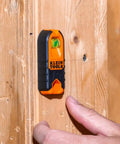 Compact Magnetic Stud Finder And Level With Bubble Vial for wood detection, installed on wooden surface.