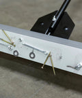 Close-up of 24 Inch Rolling Magnetic Floor Sweeper With 50 Pound Capacity And Adjustable Handle, picking up screws and nails.