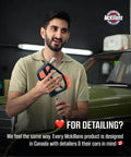 Man holding a swivel high pressure washer gun with preinstalled fittings near a vintage car, emphasizing auto detailing.