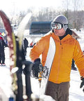 Skier wearing orange jacket and Frameless Ski Goggles With Interchangeable Lenses And UV400 Protection on snowy slope
