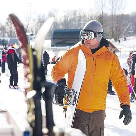 Skier wearing orange jacket and Frameless Ski Goggles With Interchangeable Lenses And UV400 Protection on snowy slope