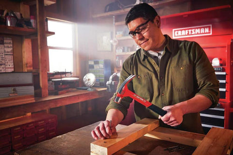 Person using 20 oz steel general purpose hammer with an ergonomic vibration-reducing grip, smooth face, one-piece forged design