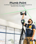 Worker using Laser Level Self Leveling 3x360 Degree Green Cross Line for construction, positioned on tripod, showing alignment lines on ceiling.