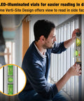 Man using versatile 2-in-1 laser level blends a 12 inch spirit level with a bright red laser, magnetic base, and long reach against wall
