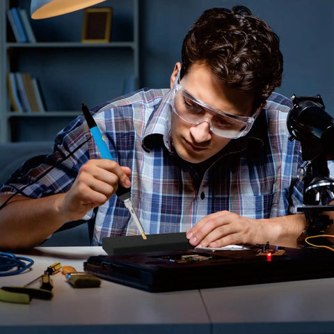 Man using Pro Heat Set Soldering Tips Kit for Easy Heat Set Inserts in 3D Printing with a soldering iron and safety glasses