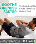 Man using Compact Textured Foam Roller for Muscle Recovery and Massage, 12 inch length, 4 inch diameter, in a gym setting