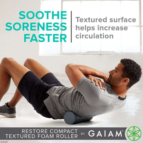 Man using Compact Textured Foam Roller for Muscle Recovery and Massage, 12 inch length, 4 inch diameter, in a gym setting