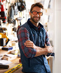 Man in workshop wearing UV Safety Glasses for 90nm-490nm UV Lamps Orange Lenses Anti-Glare Anti-Fog.