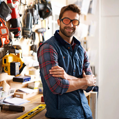 Man in workshop wearing UV Safety Glasses for 90nm-490nm UV Lamps Orange Lenses Anti-Glare Anti-Fog.