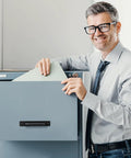 Office worker using a filing cabinet with a 12 Pack Black Barn Door Handles 5.8 Inch Aluminum Alloy Cabinet Pulls With 24 Screws Durable Sliding Door Handles for Cabinets Wardrobe Closet Shed Garage Cupboard and Drawer Doors installed.