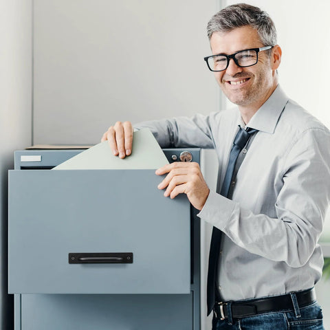 Office worker using a filing cabinet with a 12 Pack Black Barn Door Handles 5.8 Inch Aluminum Alloy Cabinet Pulls With 24 Screws Durable Sliding Door Handles for Cabinets Wardrobe Closet Shed Garage Cupboard and Drawer Doors installed.