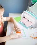 Child using the All In One Die Cutting And Embossing Machine For Scrapbooking And Card Making 9 Inch A4 Opening Manual Starter Kit By VEVOR