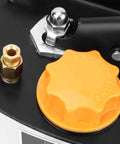 Close-up of manual lubrication pump with orange control knob and metal fittings for CNC machine tools, machining centers, and industrial equipment.