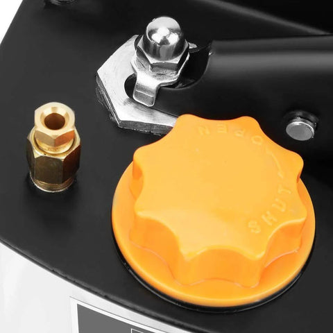 Close-up of manual lubrication pump with orange control knob and metal fittings for CNC machine tools, machining centers, and industrial equipment.