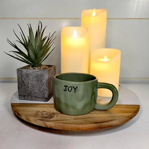 13 Inch Marble And Acacia Wood Lazy Susan Rotating Serving Tray with candles, plant, and green mug, enhancing table decor.