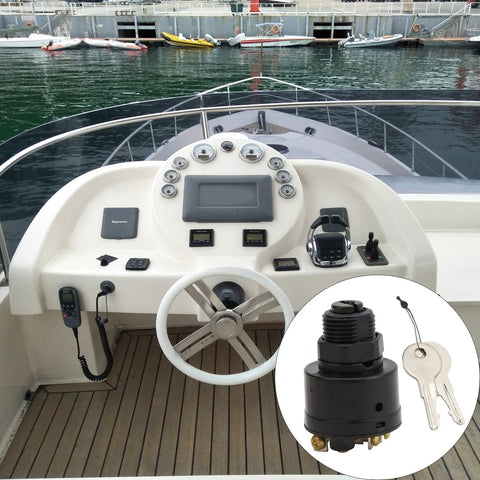 Marine ignition switch with keys installed on white boat helm; close-up inset shows the switch.