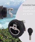 Durable marine cam latch with nylon body and 316 stainless steel cam bars visible with key and beach background