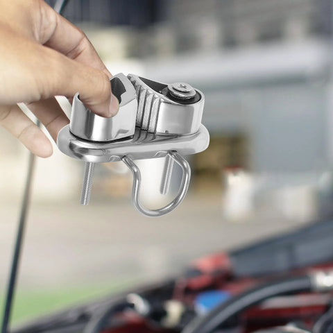 Polished stainless steel cam cleat for boats with two mounting bolts and a D-ring, front view
