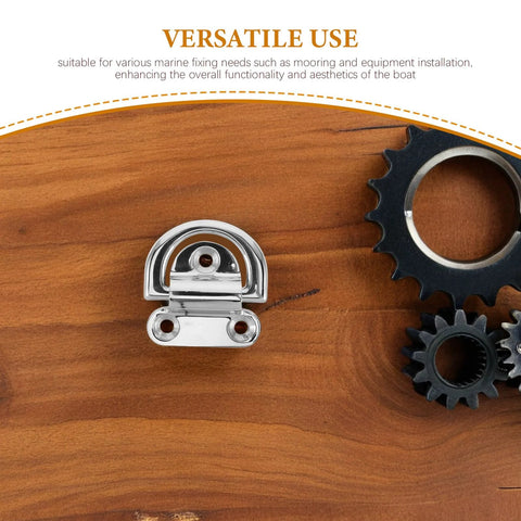 Front view of polished stainless steel 316 D-ring tie-down anchor with surface-mount base on wood