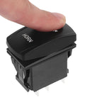 Close-up of black marine-grade push-button horn switch for boats