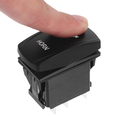 Close-up of black marine-grade push-button horn switch for boats