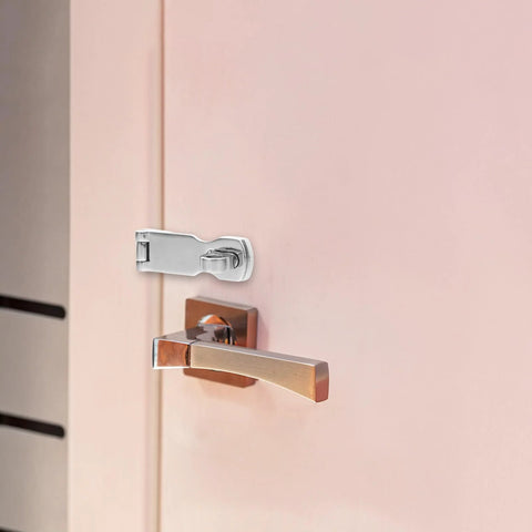 Marine-grade stainless steel gate lock hasp with swivel padlock eye, 75x25mm, installed on a pink door