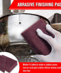 Hand using Maroon General Purpose Scrub Pad 6x9 Inches on metal pot for cleaning.