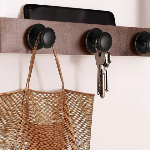 Image of 8 Pack Matte Black Self Adhesive Cabinet Knobs Set used to hang keys and a bag on a wooden rack.